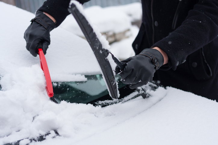 Driver Clean His Car After Snowfall