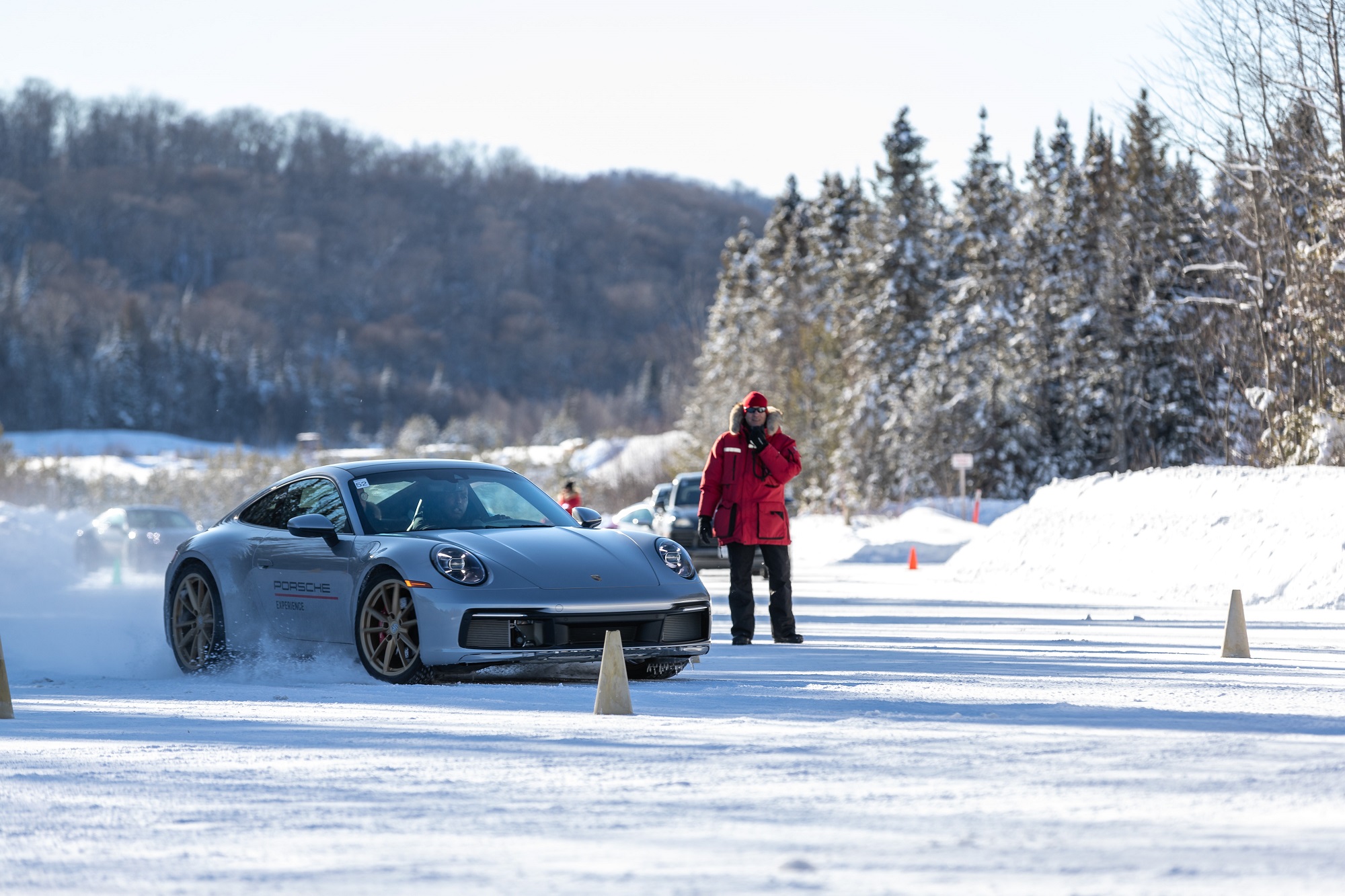 Porsche 911 prata em meio a cones preparando para entrar na curva do exercício