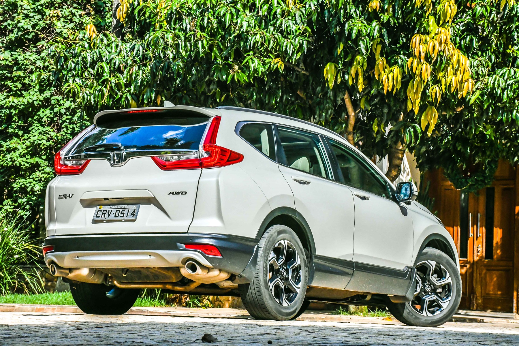 Honda CR-V branco de traseira com árvores ao fundo