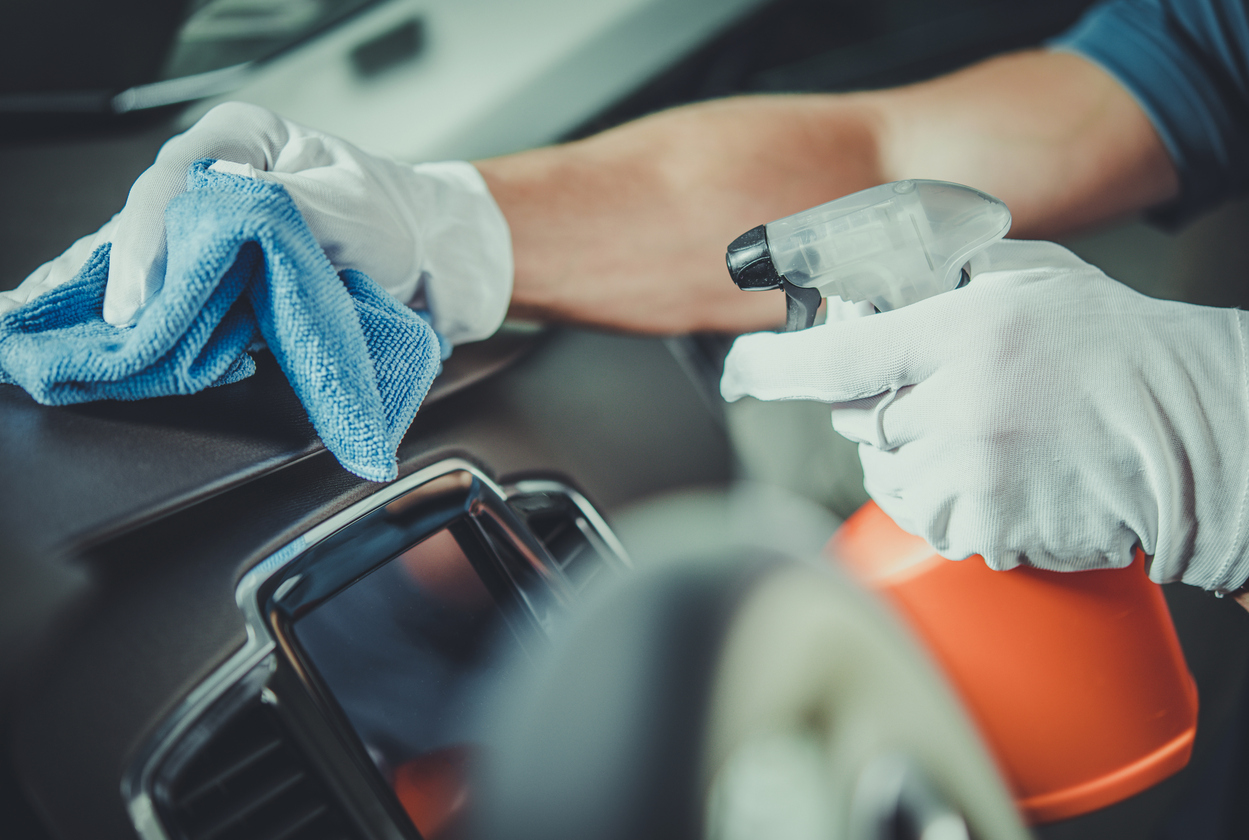 Worker Cleaning Car Dashboard