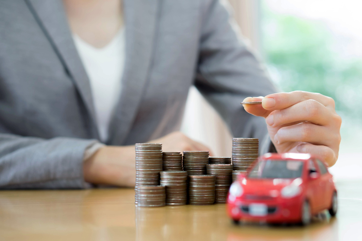 Businesswoman A Toy Car And A Stack Of Coins