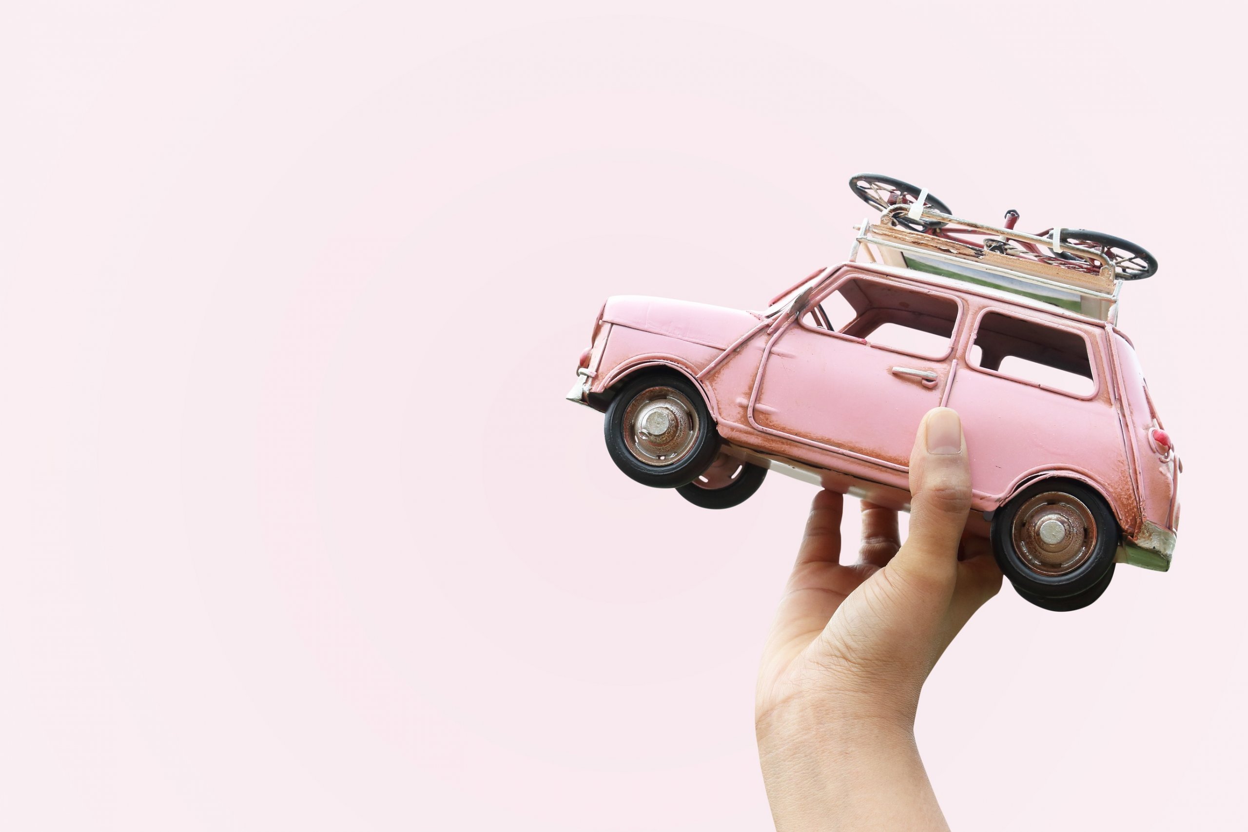 Hand,holding,classic,mini,model,with,bicycle,,travel,concept