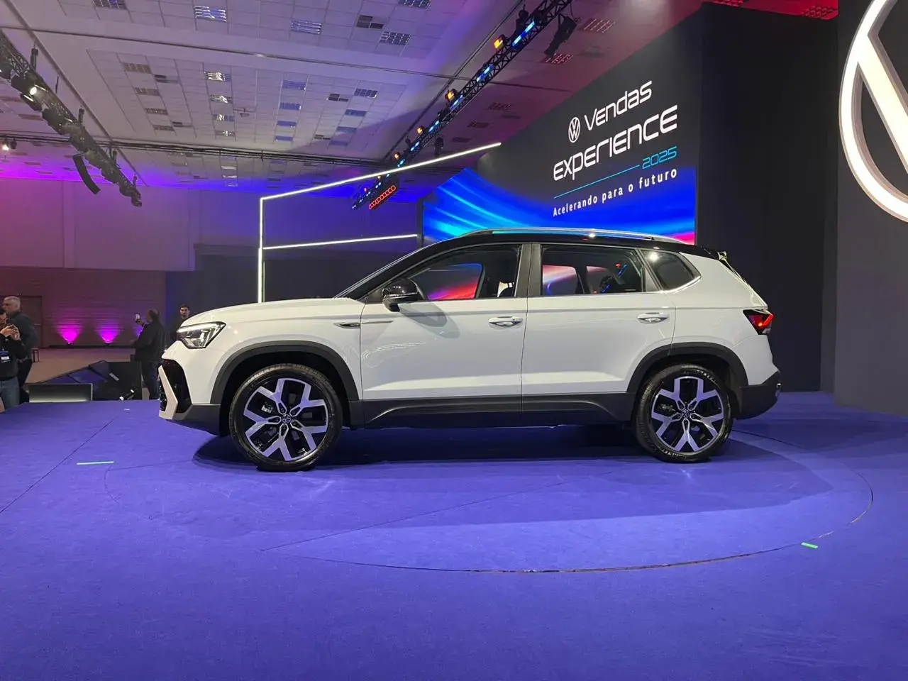 Volkswagen Taos 2026 branco com teto preto em posição lateral