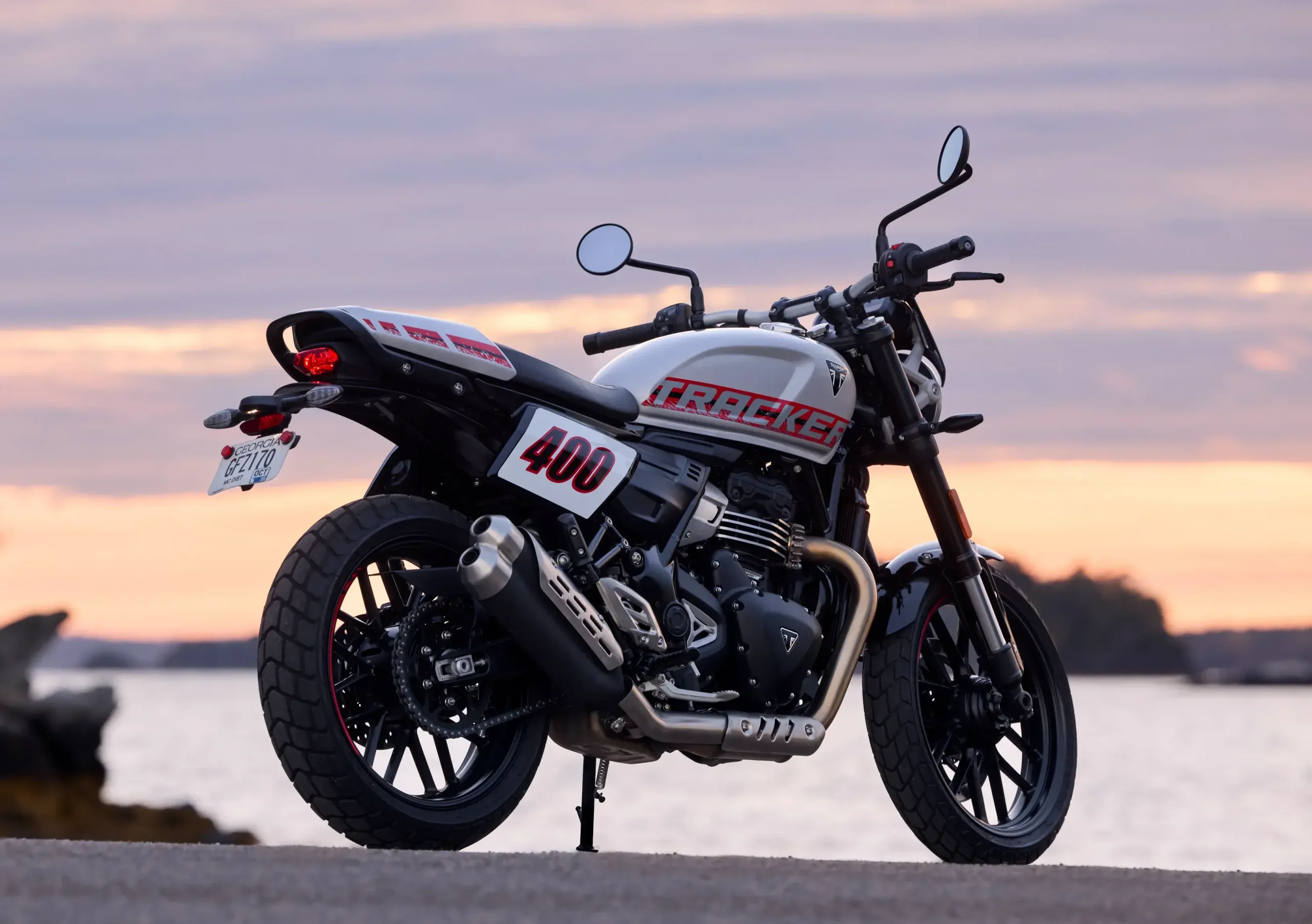 A Triumph Tracker 400 tem banco quase reto, capa que simula monoposto e escape duplo voltado para cima