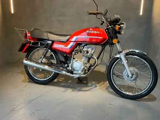 Honda CG 125 clássica, vermelha com detalhes azuis, em bom estado de conservação, ideal para quem busca opções até 5 mil reais.