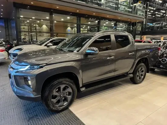 Imagem de uma Mitsubishi L200 Triton no showroom, carro de jantar de tamanho médio com design robusto e moderno, disponível para venda atualmente.